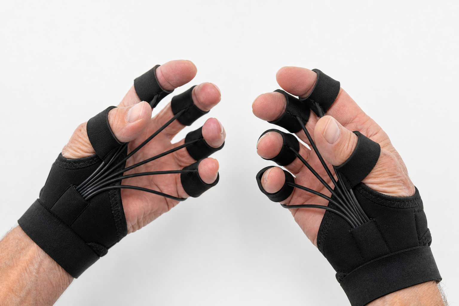 Senior's hands wearing resistance gloves showing elastic bands across fingers
