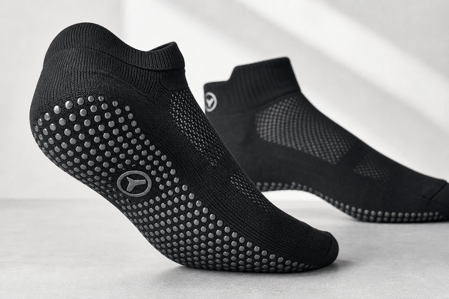 Close-up detail of non-slip grip sock showing rubber dots, breathable fabric, and ankle support