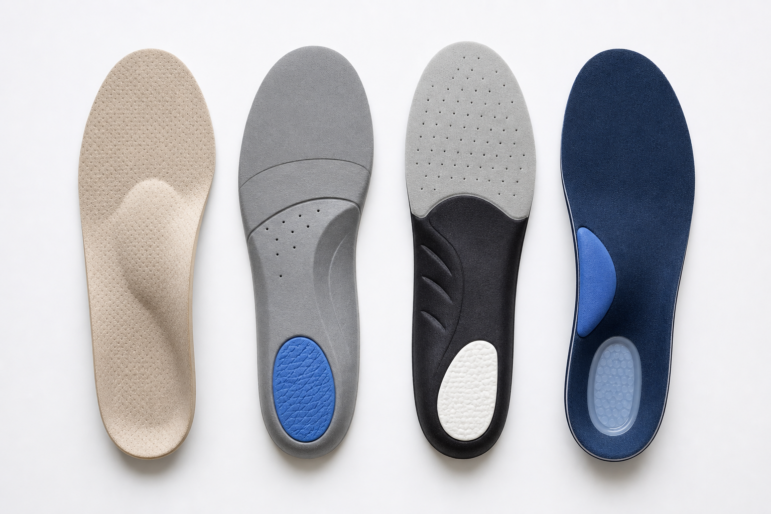 Several different orthopedic insoles arranged side by side showing varying arch support and cushioning designs